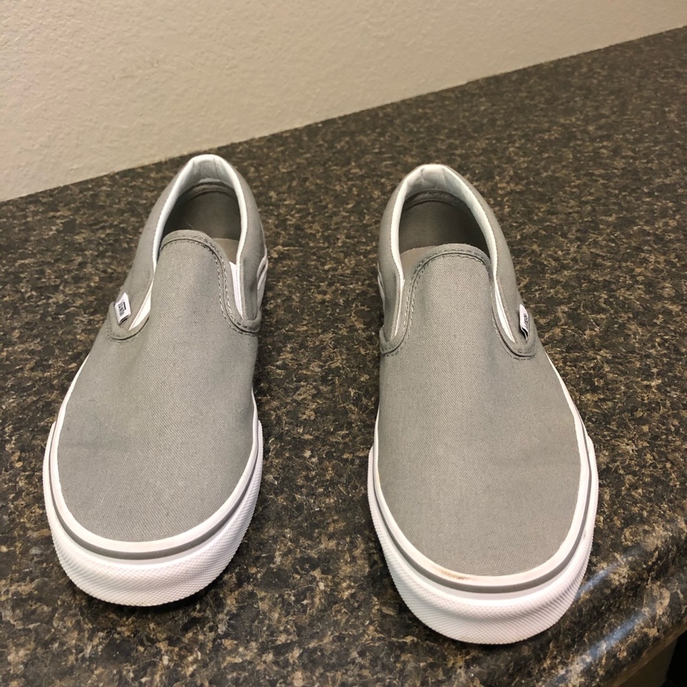 Gray and white slip on vans
